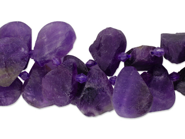 Bring organic style to your designs with this Dakota Stones amethyst rough top-drilled 25 x 18mm bead strand.  These beads feature a teardrop shape in a natural looking rough cut.  With their larger size, they will stand out in your designs. These beads feature deep purple color that will work well with gold, lush green, copper, and more. Amethyst is the official birthstone of February. Metaphysical Properties: This stone's name is derived from the Greek word amethystos, meaning "not drunken." People of ancient times believed it to protect the wearer from drunkenness. Today, this gemstone is believed to promote happiness. Because gemstones are natural materials, appearances may vary from piece to piece. Size: 25 x 18mm, Hole Size: 0.8mm