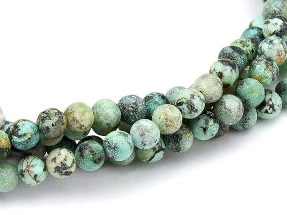 Decorate designs with the unique color of the Dakota Stones 4mm matte African Turquoise Jasper round beads. Available by the strand, these beads feature a perfectly round shape. They are small in size, so you can use them as spacers or as pops of color in earrings. Each bead features turquoise blue color with a black matrix and a matte surface. This stone is mined in Africa and is actually a type of spotted teal Jasper rather than turquoise. It is given its industry name because the matrix structure and shade is similar to that of turquoise. It has a Mohs hardness of 6. Metaphysical Properties: Often called the stone of evolution, African Turquoise Jasper encourages growth and development not only in the body, but in the mind. Some spiritualists believe that it will attract money to the wearer.Because gemstones are natural materials, appearances may vary from piece to piece. Each strand includes approximately 52 beads.
