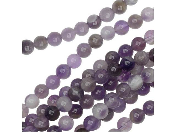 The natural color of these dog teeth amethyst 6mm round beads from Dakota Stones will create regal style in your designs. These beads feature a round shape for a classic look you can add to necklaces, bracelets and even earrings. The versatile size means these beads work anywhere. These beads feature a swirl of purple and white color. Mined in Africa, dog teeth amethyst is a combination of amethyst and white quartz mixed together in a striped, chevron pattern. It is named for its resemblance to the dog tooth violet. This stone is also known as chevron amethyst. Metaphysical Properties: Dog teeth amethyst is said to help remove resistance to change and to dissipate and repel negativity of all kinds.Because gemstones are natural materials, appearances may vary from piece to piece. Each strand includes approximately 34 beads. Our amethyst beads have nice, deep color, but may show natural inclusions.