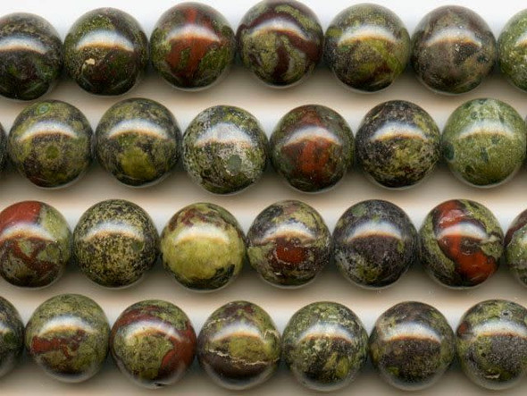 Fill your designs with mystical color using the dragon blood jasper 10mm round beads from Dakota Stones. These orb-like beads feature mottled green colors splashed with deep red tones. The two primary colors contrast and complement each other to form striking jasper. Mined only in western Australia, the local legend surrounding this gemstone says that it is the remains of ancient dragons long dead, the green mottles representing the dragons' scales and the red matrix representing spatters of blood. Dragon blood jasper is part of the quartz family. Metaphysical Properties: Dragon blood jasper enhances courage, strength and vitality.Because gemstones are natural materials, appearances may vary from bead to bead. Each strand includes approximately 20 beads. 