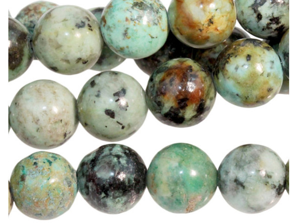 Add gemstone style to your next design with these beads from Dakota stones. These beads are perfectly round in shape and feature a versatile size that you can use in all kinds of designs. These beads would look wonderful in matching necklace and bracelet sets. Their large stringing hole makes these beads great for use with thicker stringing materials. This stone is mined in Africa and is actually a type of spotted teal Jasper rather than turquoise. It is given its industry name because the matrix structure and shade is similar to that of turquoise. It has a Mohs hardness of 6. Metaphysical Properties: Often called the stone of evolution, African Turquoise Jasper encourages growth and development not only in the body, but in the mind. Some spiritualists believe that it will attract money to the wearer. Because gemstones are natural materials, appearances may vary from bead to bead.