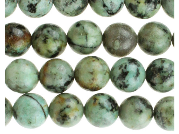 Add gemstone style to your next design with these beads from Dakota stones. These beads are perfectly round in shape and feature a versatile size that you can use in all kinds of designs. These beads would look wonderful in matching necklace and bracelet sets. Their large stringing hole makes these beads great for use with thicker stringing materials. This stone is mined in Africa and is actually a type of spotted teal Jasper rather than turquoise. It is given its industry name because the matrix structure and shade is similar to that of turquoise. It has a Mohs hardness of 6. Metaphysical Properties: Often called the stone of evolution, African Turquoise Jasper encourages growth and development not only in the body, but in the mind. Some spiritualists believe that it will attract money to the wearer. Because gemstones are natural materials, appearances may vary from bead to bead.
