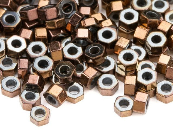 Add warmth and contemporary flair to designs with these hematite beads from Dakota Stones. These beads feature a six-sided hexagon shape. They are tiny in size, so you can use them as spacers in all kinds of looks. They are a welcome addition to necklaces, bracelets, and earrings. String several together for a fun effect. These beads feature a rich metallic copper glow. Metaphysical Properties: Often called "The Blood Stone," hematite is a great stone for physical and mental healing.Because gemstones are natural materials, appearances may vary from piece to piece. Each strand includes approximately 194 beads.