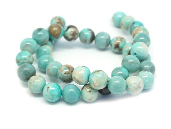 A beautiful blend of earthly color fills these terra agate beads from Dakota Stones. These beads feature a mix of greenish-blue and brown, creating patterns like miniature Earths with the brown spaces like continents in the vast ocean. Terra agate is a form of chalcedony made of quartz. These beads are treated and dyed agate. Because gemstones are natural materials, appearances may vary from piece to piece.