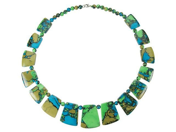 Get creative in your style with this necklace from Dakota Stones. This finished necklaces features tri-colored turquoise beads. Some of the beads are small rounds, while a graduated collar set takes center stage. You can wear this necklace as it is, or cut the strand and use the beads however you want. You'll love the mix of green, blue and mossy brown colors. Because gemstones are natural materials, appearances may vary from bead to bead. Please note that these beads are composite, stone fragments bound together by resin, heat, and pressure. Stone fragments and resin may also be dyed to produce vibrant color and pattern.Round Bead Size 6mm, Trapezoid Beads range from about 16 x 24mm to about 35 x 29mm