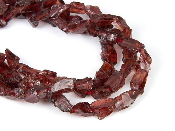 Rich style can be yours with the Dakota Stones 6x8mm garnet rough nugget beads. Available by the strand, these gemstone beads take on jagged, rock-like shapes. The deep red color is great for dramatic and daring styles. Pair them with flashy silver, bold black and more. Add them to necklaces, bracelets and earrings for a stunning display. Garnet can be found all over the world and is said to be a stone that utilizes creative energy.Because gemstones are natural materials, appearances may vary from piece to piece.Length 5.5-14.5mm, Width 4.5-9mm