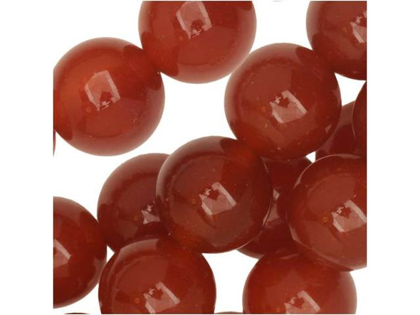 Be inspired by these Dakota Stones Carnelian round beads. Carnelian is a glassy, translucent stone that can appear with such bright orange hues that the ancient Egyptians called it the setting sun. Most deep red Carnelian has been heat treated to darken the beautiful orange and red tints that are created by iron oxides in the stone. Ancient warriors wore Carnelian for courage and power, and it has been used throughout history for various purposes, including to ward off illness and the Plague. Because gemstones are natural materials, appearances may vary from bead to bead.