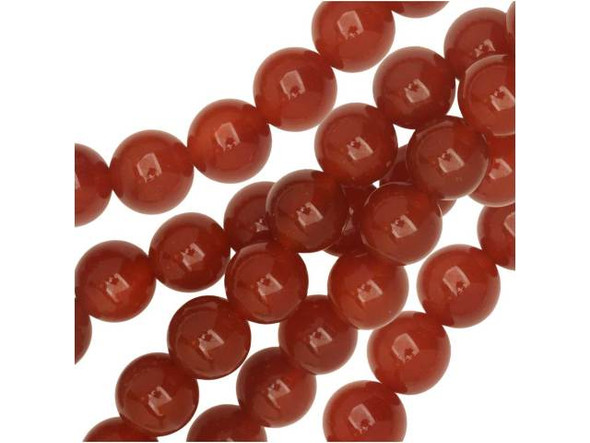 Be inspired by these Dakota Stones Carnelian round beads. Carnelian is a glassy, translucent stone that can appear with such bright orange hues that the ancient Egyptians called it the setting sun. Most deep red Carnelian has been heat treated to darken the beautiful orange and red tints that are created by iron oxides in the stone. Ancient warriors wore Carnelian for courage and power, and it has been used throughout history for various purposes, including to ward off illness and the Plague. Because gemstones are natural materials, appearances may vary from bead to bead.