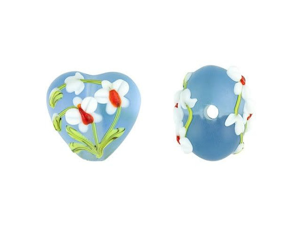 For a cheerful display, add this Grace Lampwork bead to your jewelry designs. This bead features a subtle puffed heart shape. Each side is decorated with white and red flowers on a sky blue background. The stringing hole runs vertically through the heart, so you can showcase it as a pendant on a head pin or add it to your stringing projects. It's perfect for spring-themed designs. This item is handmade, so appearances may vary.
