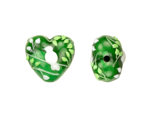 Go green with this Grace Lampwork bead. This bead features a subtle heart shape and a puffed dimension that will stand out in your jewelry designs. Both sides are decorated with a white bird on white branches along with light green branches and leaves. The inside of the glass shimmers with a forest green color. You can add this bead to a head pin for a quick pendant or try it at the center of a bracelet design. This item is handmade, so appearances may vary. Dimensions: 19 x 18mm, Hole Size: 2.5mm