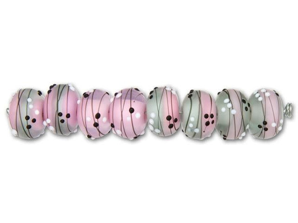 For a sweet look, try the Grace Lampwork Princess Party roundel beads in your designs. These rounded beads feature pink and gray frosted glass decorated with black lines and black white dots. The pink color and elegant style adds the perfect princess style. Use them in feminine looks. These beads feature a versatile size that will work well in necklaces and bracelets.This item is handmade, so appearances may vary. Diameter 12.5mm, Hole Size 2.6mm/10 gauge, Length 8-8.5mm