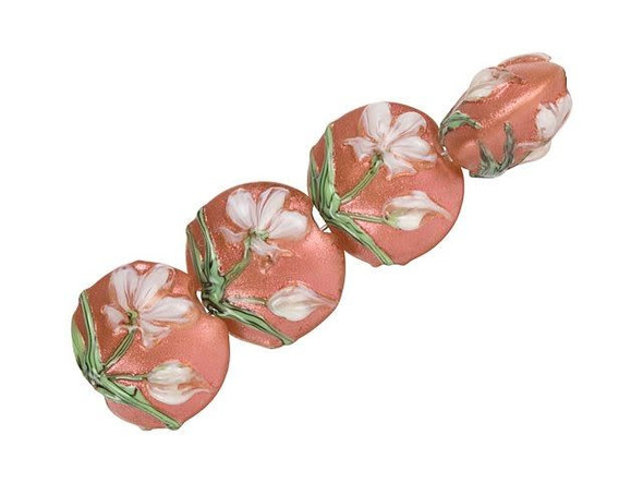 Charming style fills these Grace Lampwork beads. These beads feature a puffed, round lentil shape and each one features a raised design of white flowers with green stems blooming on a shimmering sunset coral pink background. They are perfect for spring and summer styles. This design is displayed on both sides of each bead, so they will look great anywhere. You can slide these beads onto a head pin for an instant focal, or string them into a cute bracelet design. This item is handmade, so appearances may vary.
