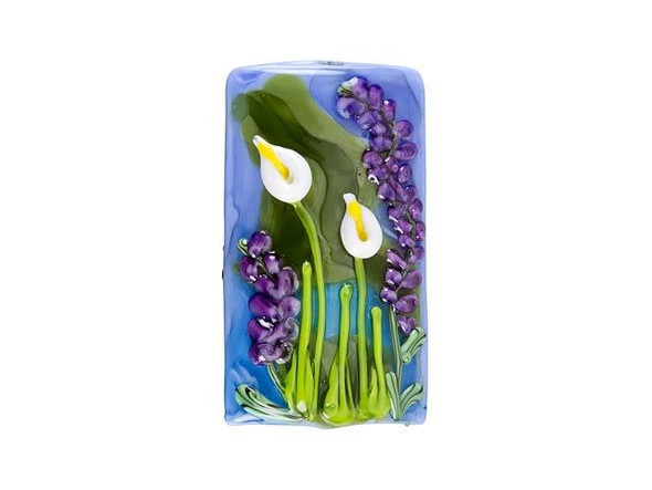 Bring floral beauty to designs with this Grace Lampwork kalera bead. This bold focal bead is rectangular in shape and features a puffed dimension, so it's sure to stand out in your style. Both sides of the bead feature a raised design of purple and white flowers on a blue and green background. It will put you in mind of a peaceful lake at springtime. String this bead onto a head pin to turn it into a pendant, or string it in an asymmetrical necklace design.This item is handmade, so appearances may vary. Length 38-38.5mm, Width 20-21mm