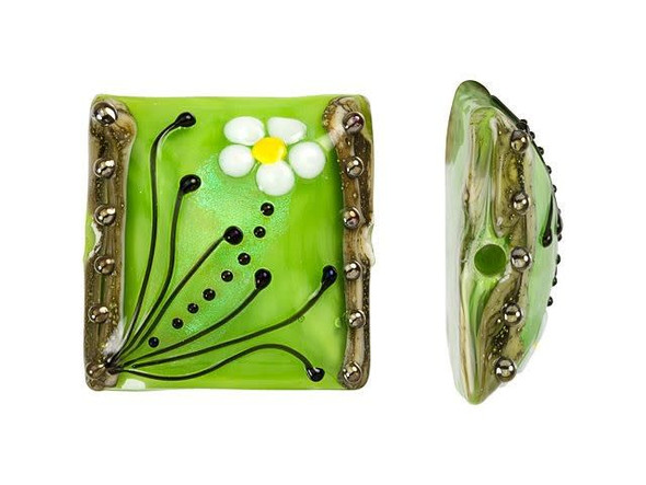 Go green with this Grace Lampwork bead. This bead features a square shape with a domed front. The front is decorated with a white and yellow daisy and black swirls and dots. The inside of the glass shimmers with a chartreuse green color. The back is flat and undecorated. String this bead onto a head pin for a quick pendant or try it at the center of bead embroidery. This item is handmade, so appearances may vary.
