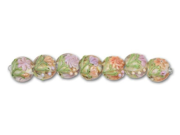 Provide your designs with delicate detail using these floral mix disc beads. Each of the handmade glass lampwork beads in this seven-piece set features a different design. The beads all have a white center surrounded in clear glass and decorated with light orange or purple flowers. Some beads have dots as accents, while others display fragile buds. These beads are perfect for spring or pastel designs.This item is handmade, so appearances may vary. Length 13-14mm, Width 14.5-15mm