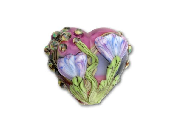 A cluster of purple flowers with bright green stems spreads across the surface of this vibrant pink and purple free style heart bead. This bead was handmade by a glass artisan using an elaborate pattern that is perfect for a focal point in your designs.This item is handmade, so appearances may vary. Length 18.5-19mm, Width 21-21.5mm
