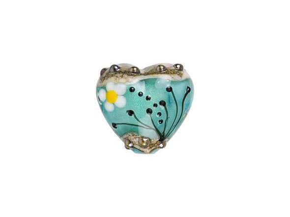 For a fun display of style, try this Grace Lampwork bead. This bead features a sweet heart shape with a puffed dimension. Both sides of the bead are decorated with a white and yellow daisy and black swirls and dots. The inside of the glass shimmers with a glittering seafoam color. You can string this bead onto a head pin to turn it into a pendant or try it on a beaded strand. This item is handmade, so appearances may vary.Hole Size 2mm/12 gauge, Length 19mm, Width 19.5mm