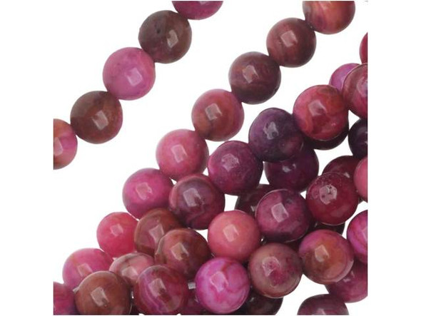 For a touch of fun color in your projects, try these Dakota Stones beads. They feature deep pink color with swirling patterns. They are small in size, so they will bring fun pops of color to necklaces, bracelets, and earrings. Mexican crazy lace agate is normally an opaque white gemstone with swirling patterns, but these beads are color enhanced with pink coloring to emphasize these beautiful patterns. Color enhancing is common amongst agates to make them fashionably relevant. They have a Mohs hardness of 6.5-7. Metaphysical Properties: Often called the happy stone, crazy lace agate promotes laughter and optimism. Because gemstones are natural materials, appearances may vary from bead to bead. Each strand includes approximately 52 beads.