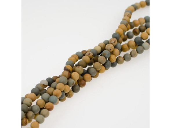 Earthy matte Wild Horse Jasper beads offer swirls, spots, and bands predominantly in shades of brown, tan, and greenish-gray. These semiprecious beads are cut from rough found in Wild Horse Canyon in Oregon, USA. The gemstone is also known as wildhorse picture jasper, American picture jasper, and owyhee jasper. As with other true jaspers, wild horse jasper is an opaque, metamorphic rock containing microscopic "grains" of crystalline quartz. Jaspers have been popular since the ancient world. They are said to give the wearer courage to speak out and bravery to achieve personal independence. Find related items below, and find out more about jasper in our Gemstone Index.