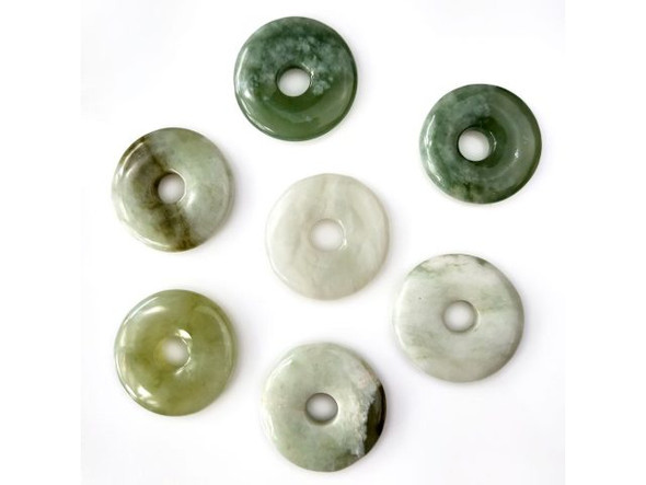 Our green jade pendants are carved from a type of serpentine. Semiprecious serpentine gemstones are translucent, waxy silicates of magnesium which often come in shades of green and have historically been confused with types of jade. Serpentine, however, is softer and less dense than most real jade. Serpentine is said to restore self-confidence, dispel fear, and enhance meditation. Types of serpentine, including green jade, are also thought to help balance female hormones and increase milk production in nursing mothers.  See Related Products links (below) for similar items and additional jewelry-making supplies that are often used with this item.