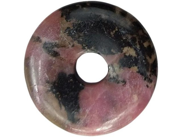 Rhodonite is an opaque, deep-rosy-pink-to-lavender gemstone with characteristic black veins called dendrites. Rhodonite is composed of manganese silicate. Most cleaning methods are safe for rhodonite (ultrasonic, etc), but like with all gemstones, avoid rough handling and extreme heat. Sometimes called the "the singer's stone," rhodonite is said to improve sound sensitivity. Many also believe it to help with the nervous system and self-esteem, and to balance trauma. It has long been considered a strong, feminine stone, as in the velvet glove over the iron fist. Natural healers associate rhodonite with the throat chakra (fifth), to help one achieve potential and dispel worry.  See Related Products links (below) for similar items and additional jewelry-making supplies that are often used with this item.