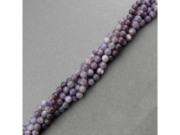 Lepidolite beads are cut from an uncommon mica that has been inconsistently available in the mineral market. Also known as gem lepidolite, lavenderine, and lepidolite mica, this semiprecious gemstone is a by-product of mining lithium. Unpolished lepidolite appears scaly, and its name derives from the Greek word lepidos, which translates to "scale." The color in these semiprecious beads ranges from violet to pale pink or white (or, occasionally, gray or yellow). Lepidolite beads can contain black markings which further add to their visual appeal. This gemstone is purported to have a calming effect, relieve muscle pain, relax nerves, and connect the heart and crown to bring spiritual understanding of pain and suffering. Lepidolite is also said to help people meet the challenges of change in their lives! Lepidolite rough is found in Zimbabwe, Sweden, Argentina, Canada (Quebec), Madagasgar, Russia, and the U.S.A. (California and Maine).  Please see the Related Products links below for similar items, and more information about this stone.