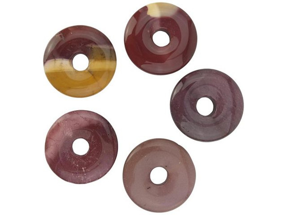 Mookaite jasper beads add warmth to gemstone jewelry with bright splashes of red, yellow and brown. These semiprecious beads are cut from an Australian jasper that is also known as mook jasper, mookakite, mookalite, mookite, mooksite, moonkite, and moukaite. This gemstone is formed as sediment in erosion zones and as a filler in cracks. It's named for where it was first found, on Mooka Station, a sheep farm on the west side of the Kennedy Range in Western Australia. Mookaite beads are considered to have healing properties and to bestow strength. The semiprecious stone is said to shield wearers from difficult situations, and to bring us into the "here and now," aiding problem assessment and decision making. Practitioners of yoga and ayurveda use mookaite for the first, second, and third chakras.  Please see the Related Products links below for similar items, and more information about this stone.