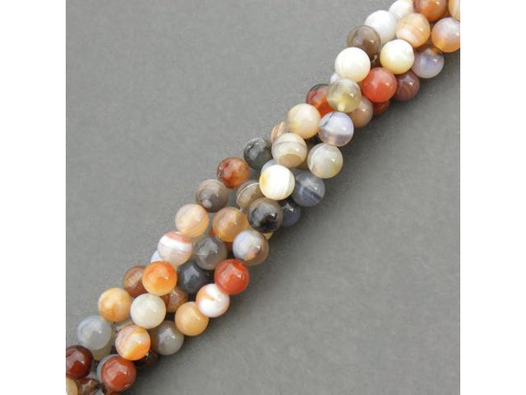 Persian Gulf Line Agate beads have all the favorite features of agate: Lovely layered stripes and swirls of mostly-translucent oranges, reds, browns, grays, peach, cream and white. These semiprecious banded agate beads are cut from a variety of chalcedony composed of quartz layers. In ancient times, agate was highly valued as a talisman or amulet. It was said to quench thirst and protect from fever. Persian magicians used agate to divert storms. Some believed that agate would render the wearer invisible, and due to its strength and durability, it is used for making ornaments or for astrological purposes. Agate is a cooling stone and is said to cure insomnia, protect against danger, promote strength and healing, and ensure a healthy life.  See the Related Products links below for similar items, and more information about this stone.