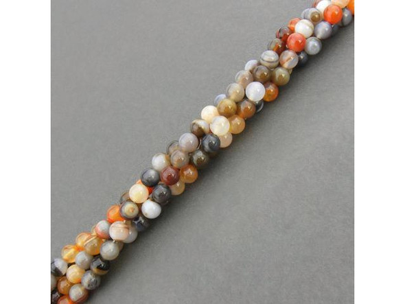 Persian Gulf Line Agate beads have all the favorite features of agate: Lovely layered stripes and swirls of mostly-translucent oranges, reds, browns, grays, peach, cream and white. These semiprecious banded agate beads are cut from a variety of chalcedony composed of quartz layers. In ancient times, agate was highly valued as a talisman or amulet. It was said to quench thirst and protect from fever. Persian magicians used agate to divert storms. Some believed that agate would render the wearer invisible, and due to its strength and durability, it is used for making ornaments or for astrological purposes. Agate is a cooling stone and is said to cure insomnia, protect against danger, promote strength and healing, and ensure a healthy life.  See the Related Products links below for similar items, and more information about this stone.