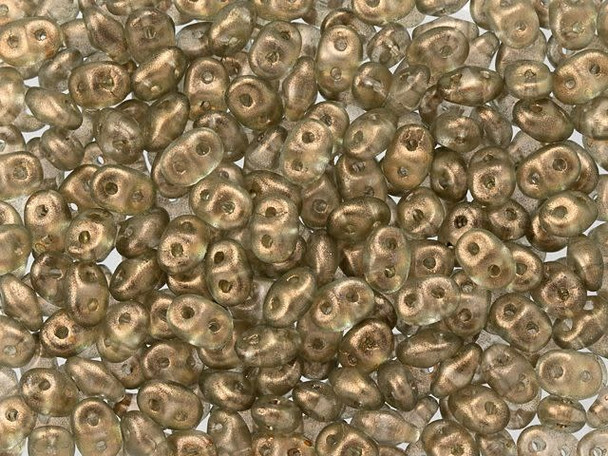 Neutral linen color with a halo of frosted golden shimmer fills these Matubo SuperDuo beads. Create intricate jewelry designs with Czech glass seed beads! Featuring a unique shape and two stringing holes, these seed beads add a special touch of creativity to your designs. They have tapered edges and nest up nicely when strung, making them ideal for floral and woven designs. Add a special touch to your jewelry with Czech glass seed beads!  