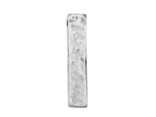 For creative and contemporary styles, try this Nunn Design bead. This bead features a long rectangular shape and an organic, artisan texture. The stringing hole is drilled through the top end of the bead, so this shape will dangle in your designs. Showcase this bold piece at the center of a simple necklace, dangle it in earrings, and more. It features a versatile silver shine that will work with any color palette.