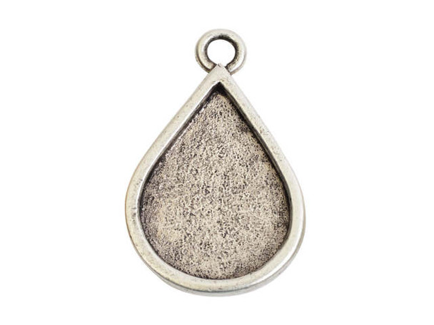 Fall in love with the elegant look of this Nunn Design pendant. This pendant features a bezel frame with an elegant teardrop shape. It's perfect for showcasing custom designs. Fill the frame with epoxy clay, use resin to add personal touches, or try other mixed media elements. The loop at the top of the pendant makes it easy to add to designs. Try it at the center of a necklace or even in bold earrings. It features a versatile silver shine. Hole Size 3.5mm, Length 36mm, Width 22.5mm