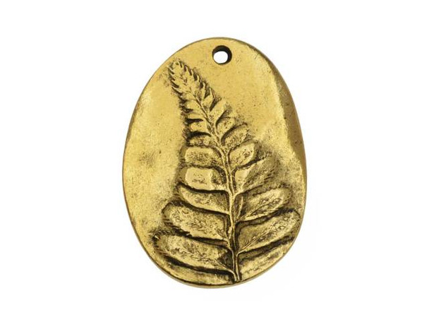 For a look inspired by nature, try this Nunn Design charm. This bold charm features an organic oval shape and a raised design of a fern frond on the front. The fern is beautifully detailed and full of lovely texture. The back of the charm is smooth and plain. Use the hole at the top of the charm to showcase this piece in your designs. It would look great at the center of a necklace. DIMENSIONS: 31 x 22mm