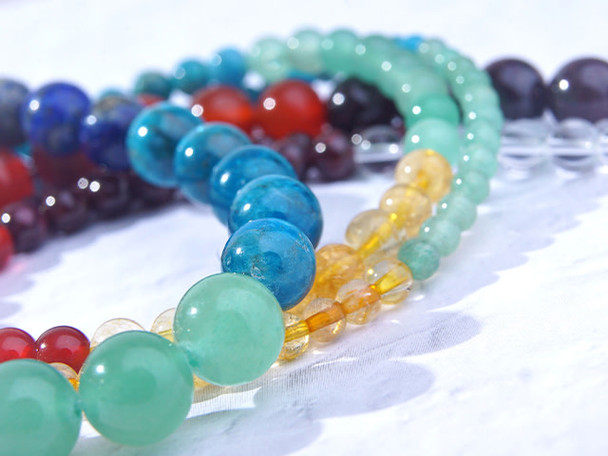This Dakota Stones Chakra Stones 10mm Round Bead Strand contains 8 different varieties of gemstones representing the different Chakras. The included gemstones are Amethyst, Lapis, Blue Apatite, Green Aventurine, Citrine, Carnelian, Red Garnet and Crystal Quartz.  These beads feature a classic round shape.Each strand includes approximately 40 beads, with about 5 in each color.Size: 10mm Hole Size: 0.8mm