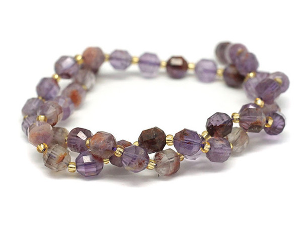 Energize your designs with this Dakota Stones cacoxenite faceted 8mm energy prism bead strand. The beads on this strand feature a faceted cut helping them catch the light. This strand features spacers between each of the beads, so you could use it as-is, or string the beads into a design. Cacoxenite is the trade name for this naturally occurring blend of seven stone types. This stone, often called the "Super Seven" or "Melody Stone" contains amethyst, clear quartz, smoky quartz, lepidocrosite, goethite, and rutile. These versatile round beads are perfect for any kind of jewelry design, from necklaces and bracelets to earrings. They feature star cut facets that really catch the light. You'll love the smoky purple and brown colors. Metaphysical Properties: Cacoxenite is said to be a healing and harmonizing stone. Because gemstones are natural materials, appearances may vary from bead to bead.