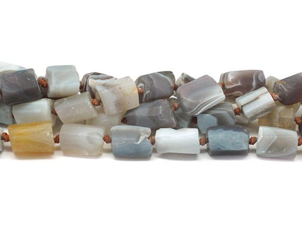 Decorate your jewelry designs with the gemstone style of these Dakota Stones beads. Botswana Agate displays highly defined parallel banding, usually in white on hues of brown, gray, pink, tan, apricot and purplish red. Botswana Agate was formed nearly 187 million years ago by lava flowing in waves from long faults in the earth. This lava rolled across the landscape, depositing layer upon layer of Quartz silicate to create the banding and patterns now prized in Botswana Agate. The beads on this strand can vary in size from about 7 x 10mm to about 8 x 13mm. Because gemstones are natural materials, appearances may vary from bead to bead.