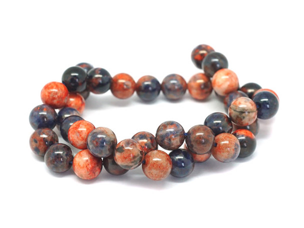 Add bold colors to your designs with this Dakota Stones dyed orange sodalite 10mm round bead strand. These beads feature a mix of bold blue and vibrant orange tones. They feature a classic round shape that is easy to add to your designs. Orange Sodalite has veins of orange, white and gray within the primarily bright to deep blue or black stone. Sodalite is named for its sodium content. Because gemstones are natural materials, appearances may vary from piece to piece.
