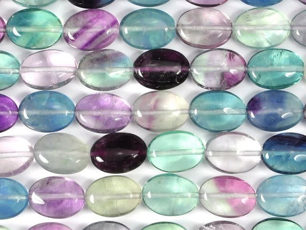 Add colorful style to your designs with the Dakota Stones banded fluorite 10x14mm oval beads. These oval-shaped beads are a great option for necklace strands, bracelets and even earrings. The beads feature purple, green and pale yellow colors. Often, more than one color occurs in a single stone. Fluorite is a colorful mineral, both in visible and ultraviolet light. The stone has ornamental, lapidary and industrial uses. Metaphysical Properties: Known as the "Genius Stone," fluorite clears the mind of illusion and enhances concentration.Because gemstones are natural materials, appearances may vary from piece to piece. Each strand includes approximately 14 beads.