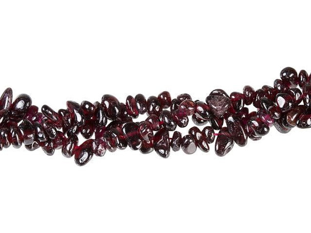 Decorate designs with these gemstone beads from Dakota Stones. These red garnet beads feature pebble-like chip shapes that will make an organic display in your designs. These beads feature dark red color that is sure to add drama to your projects. You can use these versatile beads in necklaces, bracelets, or even earrings. Pair them with round shapes or layer them together. Metaphysical Properties: Garnet is said to be a stone that utilizes creative energy.Because gemstones are natural materials, appearances may vary from bead to bead.Length 1-5mm, Width 4-11mm