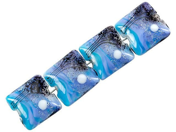 Nighttime beauty fills these Grace Lampwork beads. These beads feature a square pillow shape with a puffed dimension, so they will stand out in your jewelry designs. Both sides of each bead are decorated with a scene of tall trees and a full moon on a swirling blue background. Silver glitter adds to the magic. Showcase these beads in necklaces, bracelets, or even earrings. You'll love using them in your designs. This item is handmade, so appearances may vary.