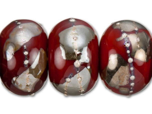 Create bold yet beautiful statements with these Grace Lampwork roundel beads. Each rounded, handmade glass bead is cast in a romantic deep red color and decorated with silver gashes and granulations, glowing with a metallic shine. These large beads are great to use as focals in a necklace or bracelet design. Try pairing them with other silver jewelry components or multiple shades of red.This item is handmade, so appearances may vary. Diameter 14-14.5mm, Length 9-10mm