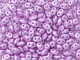 Soft lilac purple color with a pearlescent glow fills these Matubo SuperDuo beads. Create intricate jewelry designs with Czech glass seed beads! Featuring a unique shape and two stringing holes, these seed beads add a special touch of creativity to your designs. They have tapered edges and nest up nicely when strung, making them ideal for floral and woven designs. Add a special touch to your jewelry with Czech glass seed beads!  