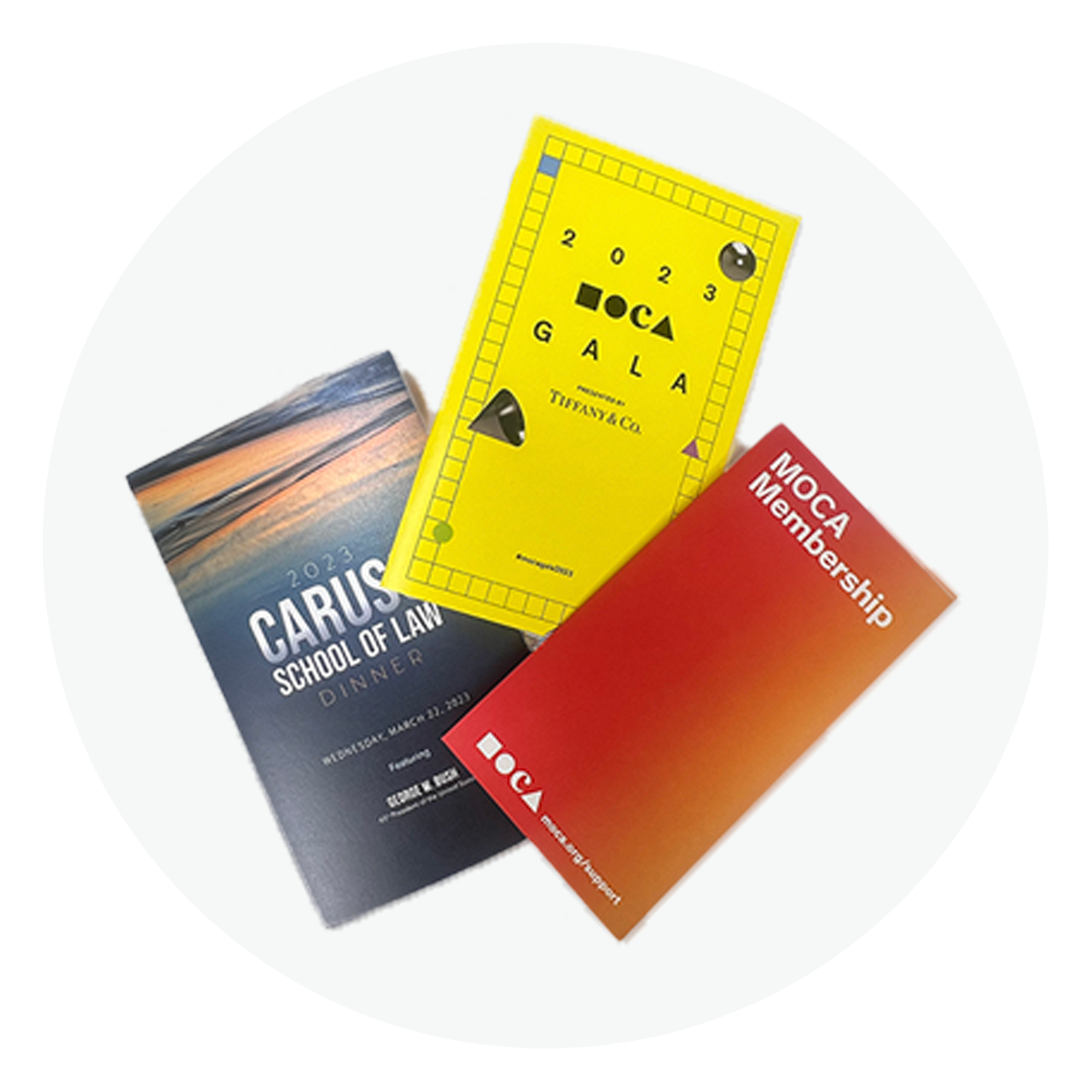 Three custom-printed event brochures with various finishes and layouts.