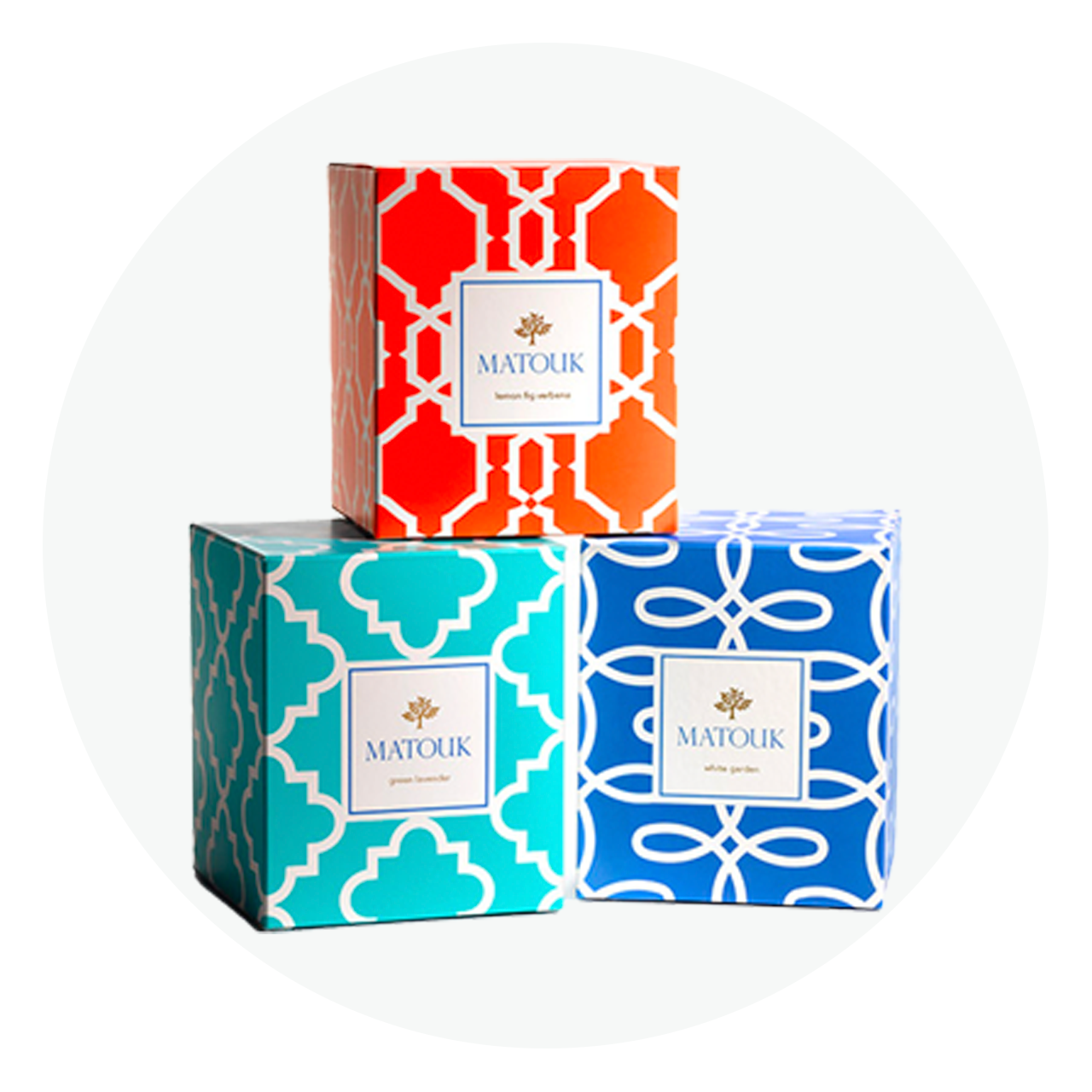 Three rigid paperboard boxes with colorful geometric pattern wraps and straight tuck closures.