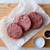 Three ground beef patties.