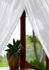 Cotton round mosquito net over a bed lifestyle view