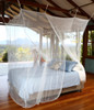 Jumbo box mosquito net draped over a King size bed