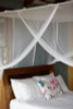 Box mosquito net over a double bed showing full coverage
