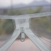 Close-up of the zip door on a pop-up freestanding mosquito net