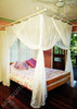 Cotton mosquito net box draped over King bed lifestyle
